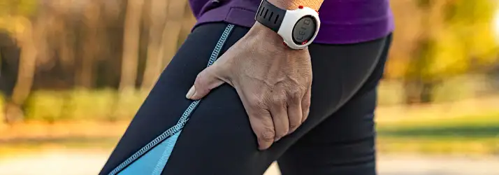 Chiropractic Allen TX Leg Pain Person holding their upper thigh.