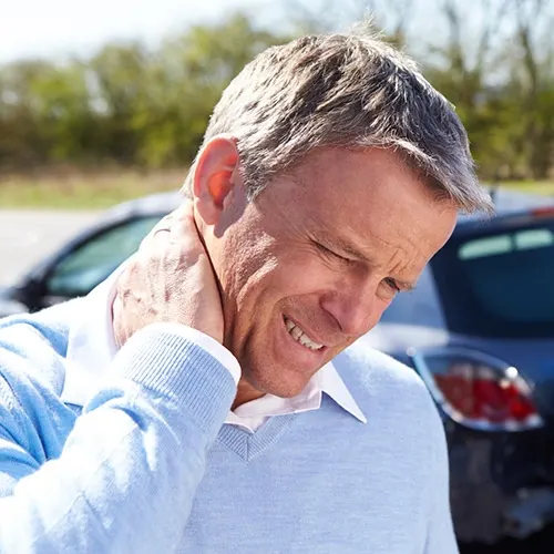 Person holding their neck in pain.