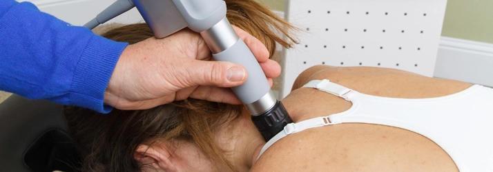 Chiropractic Allen TX Shockwave Therapy A patient receiving shockwave therapy on their shoulder.
